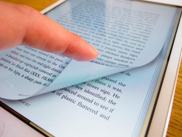 Pasar la página de un libro electrónico con un lector de iBook en un iPad mini tablet PC