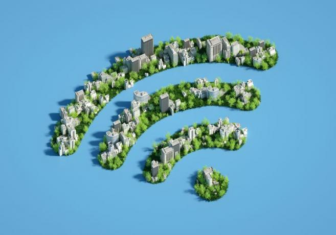 Imagen generada digitalmente de un paisaje urbano verde en forma de un símbolo Wi-Fi sobre un fondo azul