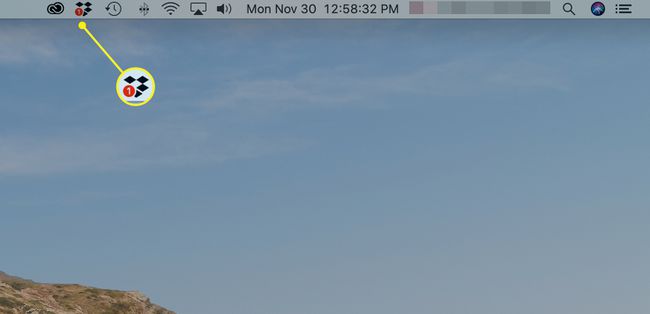 Десктоп Mac, показващ логото на Dropbox в лентата с менюта