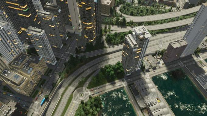 ภาพหน้าจอ Cities Skylines 2 ตึกระฟ้าใจกลางเมืองและถนนที่พลุกพล่าน