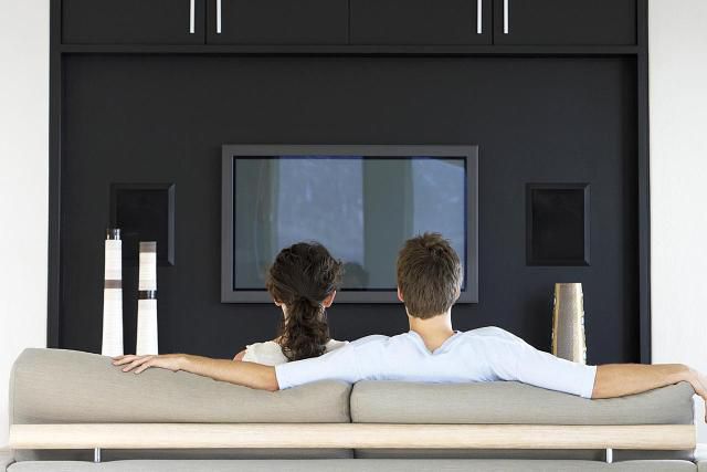 Coppia su un divano che guarda l'home theater